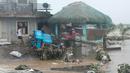 Seorang pria berjalan melewati kerusakan yang disebabkan oleh banjir bandang pada Kamis 24 Oktober 2024 di kota Libon, provinsi Albay, Filipina. (AP Photo/John Michael Magdasoc)