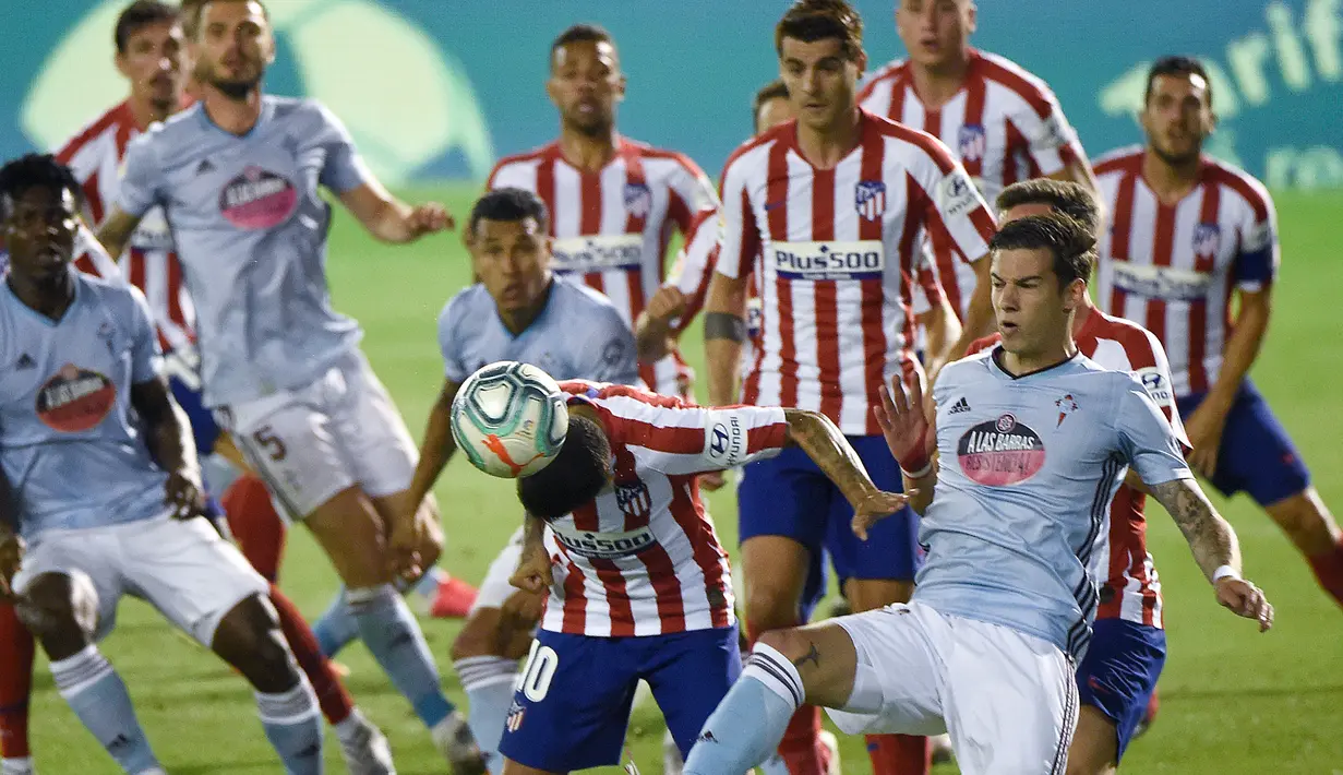 Penyerang Atletico Madrid, Angel Correa, berebut bola dengan penyerang Celta Vigo, Santi Mina, pada laga lanjutan La Liga di Abanca-Balaidos, Rabu (8/7/2020) dini hari WIB. Atletico Madrid ditahan imbang 1-1 oleh Celta Vigo. (AFP/Miguel Riopa)