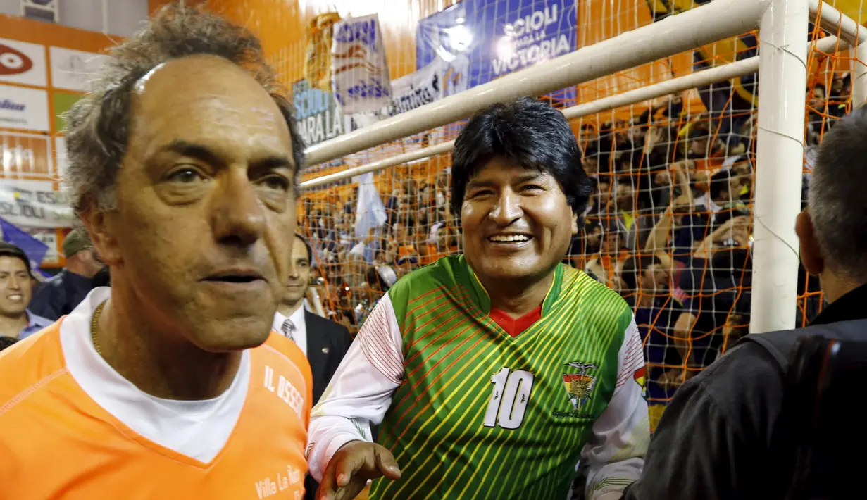 Presiden Bolivia, Evo Morales (kiri) dan Daniel Scioli, gubernur provinsi Buenos Aires dan calon presiden Argentina dari Victory, tiba untuk bermain sepak bola di Benavidez, Buenos Aires, Argentina (17/9/2015). (REUTERS/Marcos Brindicci)