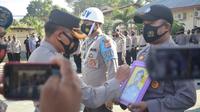 Kapolres Gorontalo, AKBP Ade Permana saat melakukan pencoretan terhadap foto Bribka Saifuddin Salamon (Arfandi Ibrahim/Liputan6.com)