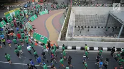 Peserta mengikuti lomba lari Milo Jakarta International 10K di kawasan Epicentrum, Jakarta, Minggu (15/7). Ajang lomba lari 10 Kilometer ini diikuti 16.000 peserta yang terbagi menjadi tiga kategori Open, Closed, dan Pelajar. (Liputan6.com/Faizal Fanani)