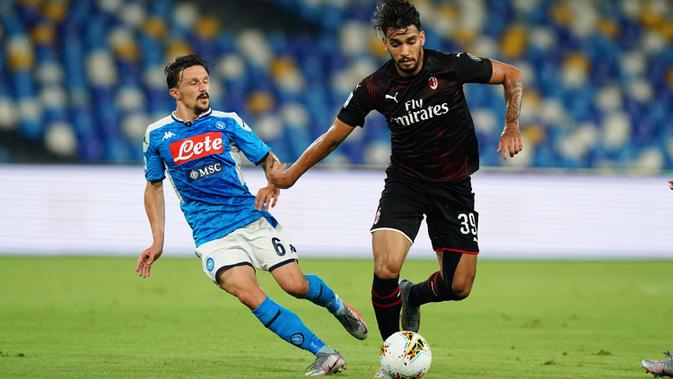Gelandang AC Milan, Lucas Paqueta menggiring bola dari kejaran pemain Napoli, Mario Rui pada pertandingan lanjutan Liga Serie A Italia di Stadion San Paolo di Naples, Italia, Minggu, (12/7/2020). AC Milan bermain imbang 2-2 atas Napoli. (Spada/LaPresse via AP)