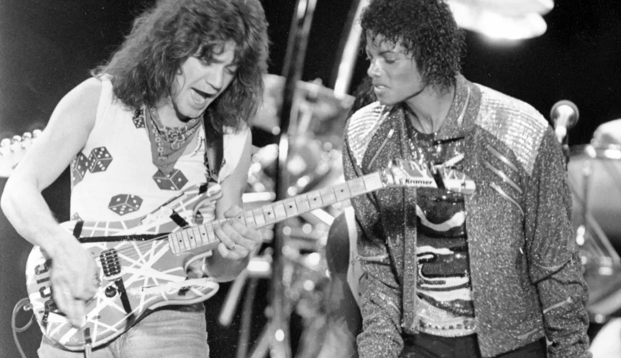 File foto 14 Juli 1984 ini menunjukkan gitaris Van Halen Eddie Van Halen (kiri) menampilkan "Beat It" bersama Michael Jackson selama konser Jackson's Victory Tour di Irving, Texas. Eddie Van Halen meninggal dunia pada Selasa pagi, 6 Oktober 2020.  (AP Photo/Kevork Djansezian, File)