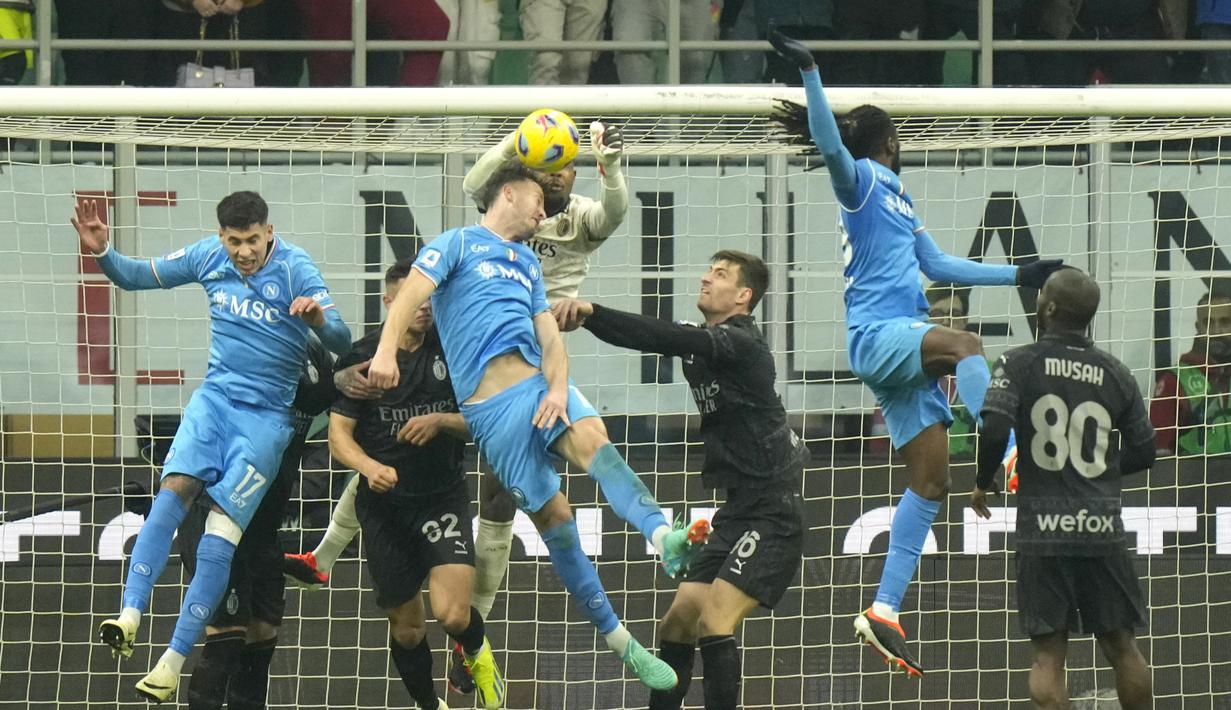 Kiper AC Milan, Mike Maignan, berusaha menangkap bola saat melawan Napoli pada laga pekan ke-24 Serie A 2023/2024 di San Siro, Senin (12/2/2024). Hasil ini membuat Milan mengemas 52 angka dari 24 laga dan mereka bertahan di posisi tiga klasemen Serie A 2023/2024. Sementara itu Napoli sekarang tertahan di posisi sembilan dengan koleksi 35 angka. (AP Photo/Luca Bruno)