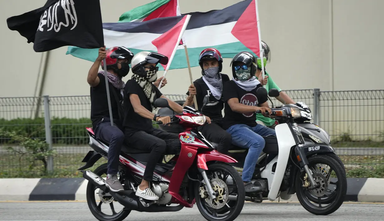 Warga Muslim mengendarai motor membawa bendera Palestina saat konvoi protes menentang serangan Israel di Gaza di luar Kedutaan Besar Amerika Serikat di Kuala Lumpur, Malaysia, Jumat (21/5/2021).  (AP Photo / Vincent Thian)