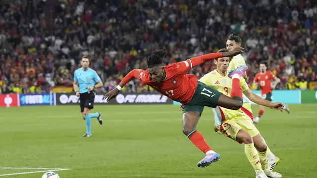 Rafael Leao dijegal lawan di laga final UEFA Nations League 2025 antara Portugal vs Spanyol, Senin (09/06/2025). (AP/Martin Meissner)