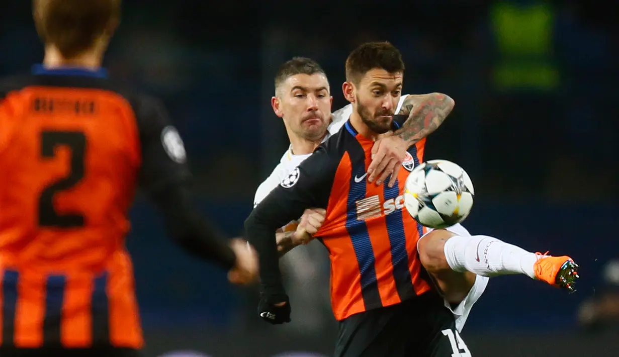 Pemain Shakhtar Donetsk, Facundo Ferreyra dan pemain  AS Roma Aleksandar Kolarov berebut bola pada leg pertama babak 16 besar Liga Champions di Oblasny SportKomplex Metalist, Kamis (22/2). Shakhtar Donetsk sukses menang tipis 2-1. (AP/Efrem Lukatsky)