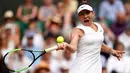 Petenis Rumania, Simona Halep mengembalikan bola ke petenis Ukraina Elina, Svitolina pada babak semifinal Wimbledon 2019 di All England Lawn Tennis Club, Kamis (11/7/2019). Mantan petenis putri nomor satu dunia itu berhasil menuju final untuk pertama kalinya di Wimbledon. (WILL OLIVER/POOL/AFP)