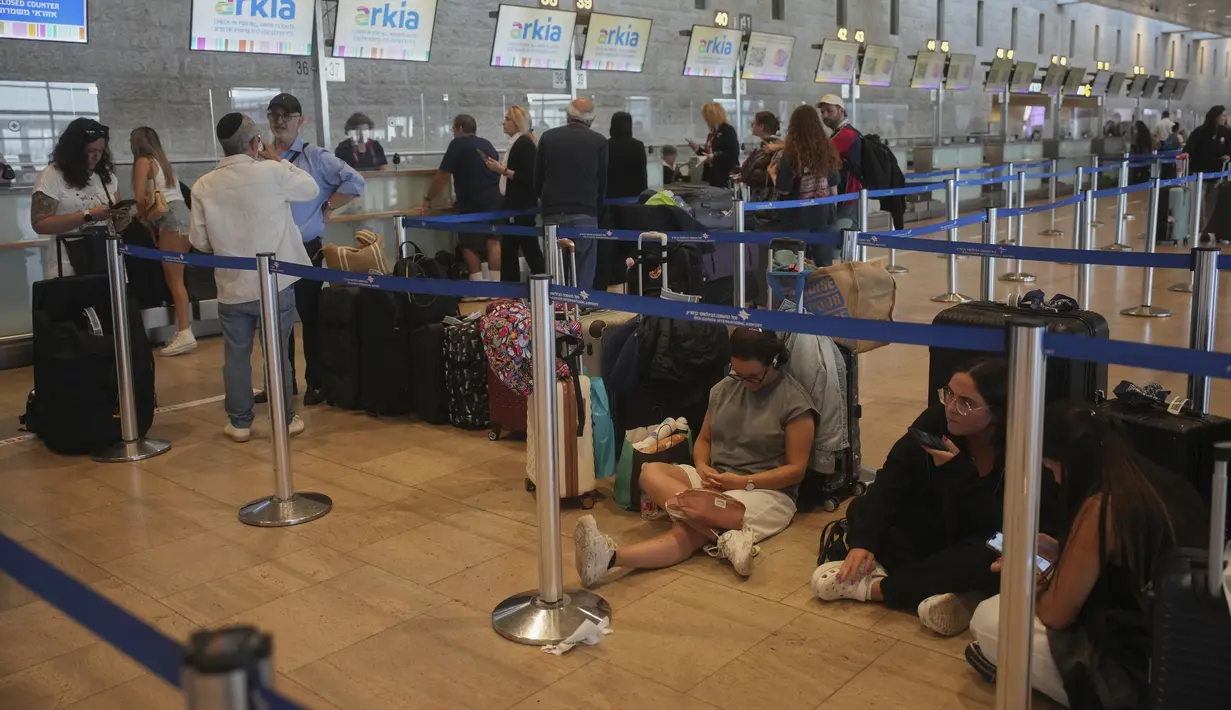 Para pelancong mengantre untuk pelaporan masuk penerbangan menyusul pengumuman gencatan senjata antara Israel dan Iran, di Bandara Internasional Ben Gurion, dekat Tel Aviv, Israel, Rabu 25 Juni 2025. (AP/Ohad Zwigenberg)