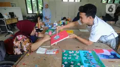 Para disabilitas menyelesaikan lukisan pada bengkel kerja unit karya YPAC di Jakarta Selatan, Selasa (27/2/2024). (merdeka.com/Arie Basuki)