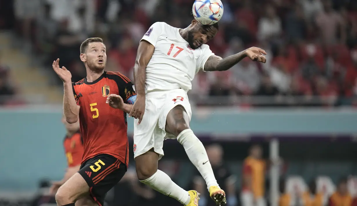 Bek Belgia, Jan Vertonghen berebut bola udara dengan pemain Kanada, Cyle Larin pada pertandingan grup F Piala Dunia 2022 Qatar di Stadion Ahmad Bin Ali di Doha, Qatar, Kamis (24/11/2022). Belgia menang tipis atas Kanada 1-0. (AP Photo/Hassan Ammar)