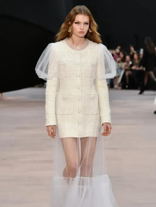 Elemen feminin seperti jeans sifon, mantel panjang wol hitam berenda, dan sepatu satin bouillonné melengkapi koleksi ini, yang tetap setia pada estetika khas Chanel yang mengutamakan kehalusan dan imajinasi. [Foto: Chanel.dok]