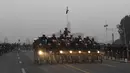 Aksi prajurit wanita dari Pasukan Keamanan Perbatasan India (BSF) beraksi di atas motor sambil membawa bendera India selama latihan untuk Parade Hari Republik di New Delhi, India, Rabu (10/1). (AFP Photo/Prakash Singh)