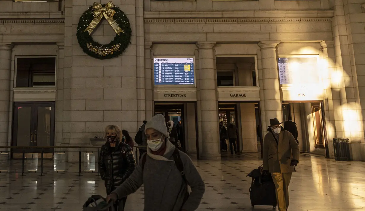 Orang-orang tiba di stasiun kereta Union Station di Washington, DC, Kamis (23/12/2021). Jutaan orang Amerika bepergian pada 23 Desember 2021, selama salah satu hari perjalanan tersibuk di musim liburan, ketika infeksi Covid dengan Omicron melampaui puncak gelombang varian Delta. (Pedro Ugarte/AFP)