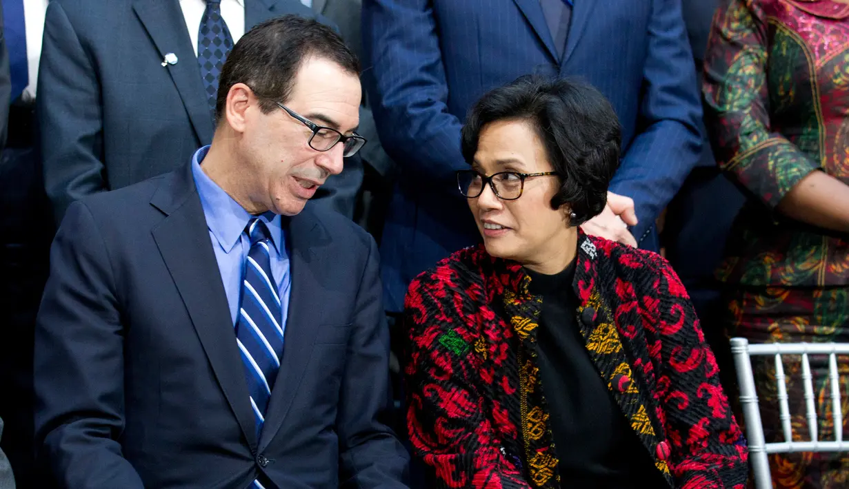 Sekretaris Menteri Keuangan Steven Mnuchin berbicara dengan Menteri Keuangan Sri Mulyani Indrawati saat akan sesi foto ketika rapat World Bank/IMF Spring di Washington, (22/4). (AP Photo/Jose Luis Magana)