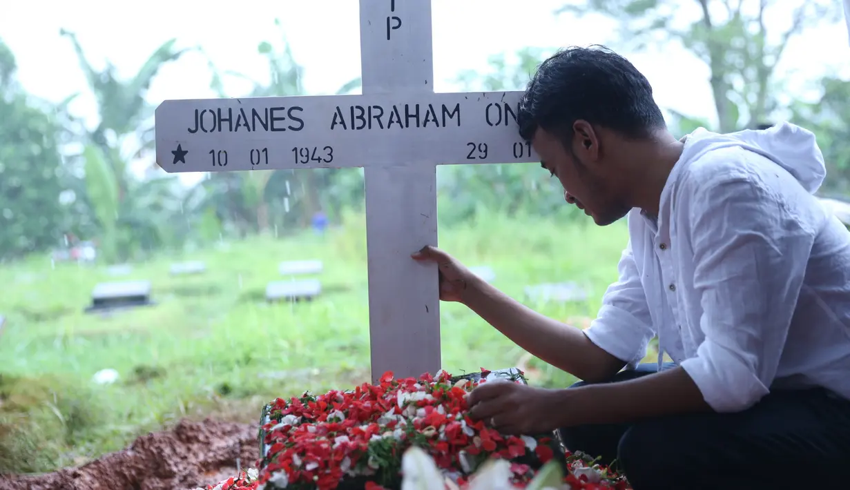 Ruben Onsu dengan mata sembab, kepala tertuduk di depan iring-iringan pembawa peti jenazah berjalan ke arah liang lahat. Sedangkan sang adik, Jordi Onsu lebih tegar. Ia membantu menggotong peti ayahnya. (Nurwahyunan/Bintang.com)