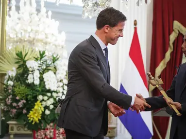 Perdana Menteri Kerajaan Belanda Mark Rutte (kiri) memberikan cindramata sebuah keris kepada Presiden Joko Widodo seusai memberikan pernyataan bersama di Istana Merdeka, Jakarta, Rabu (23/11). (Liputan6.com/Faizal Fanani)