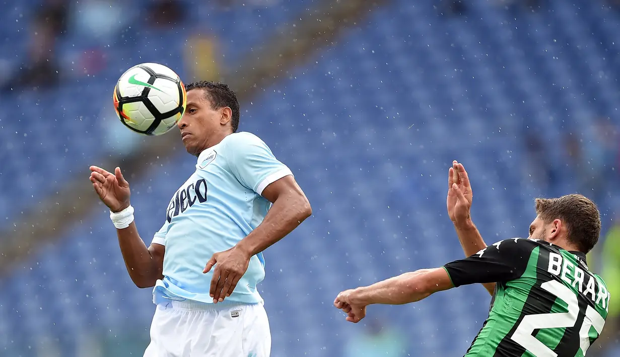 Gelandang Lazio, Ricardo Kishna (kiri) melakukan duel udara dengan pemain Sassuolo, Domenico Berardi pada lanjutan Serie A di Olympic Stadium, Roma, (1/10/2017). Lazio menang telak 6-1. (AFP/Filippo Monteforte)