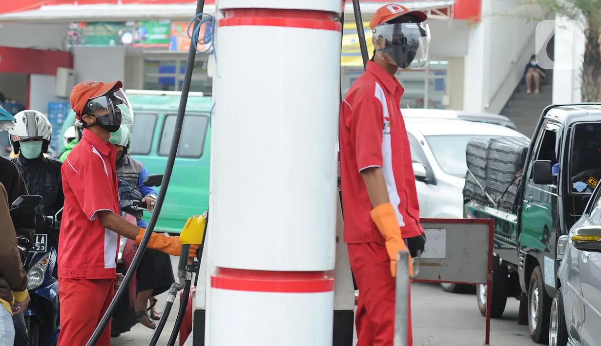 Petugas dengan sarung tangan, masker dan pelindung wajah melayani pembeli BBM di SPBU kawasan Cilendek, Bogor, Selasa (5/5/2020). Mencegah penularan Covid-19, sejumlah perusahaan memberikan pelindung diri kepada pegawai, terlebih yang berhubungan langsung dengan pelanggan. (merdeka.com/Arie Basuki)