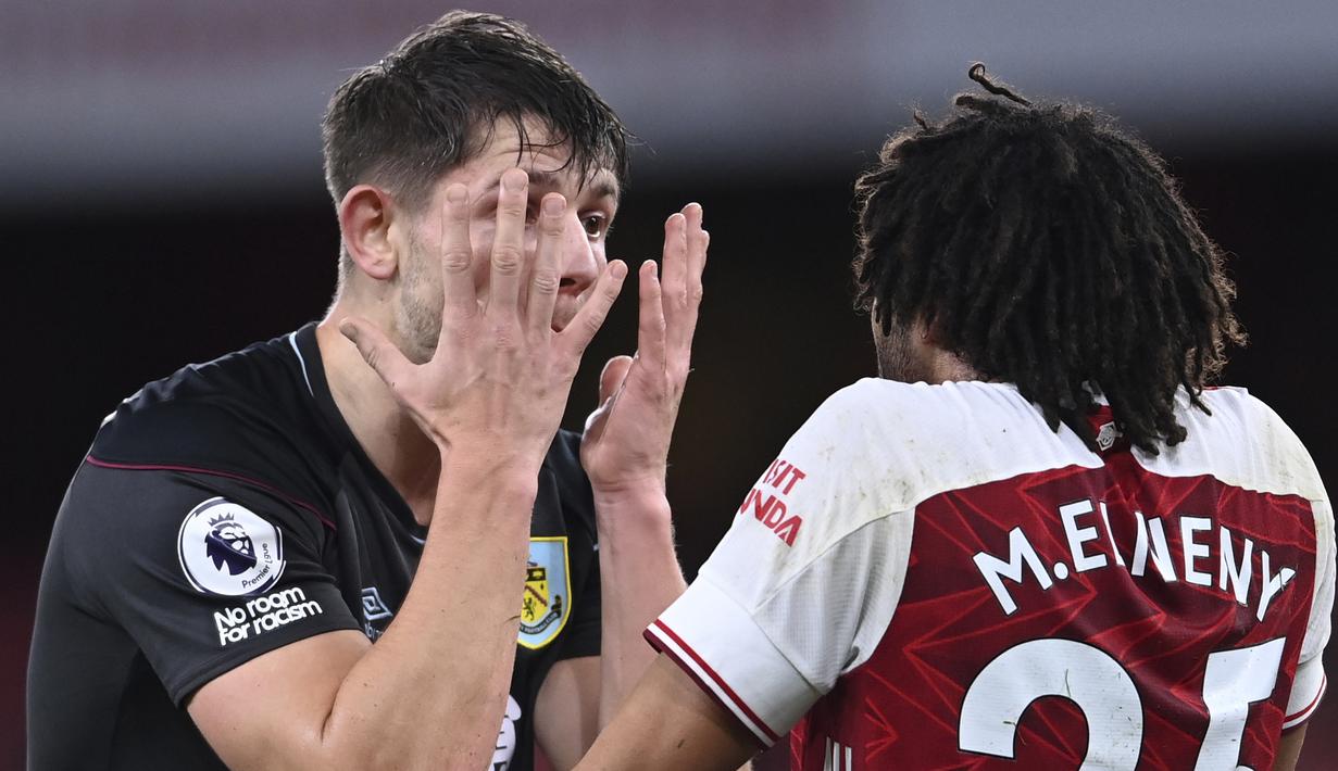 Pemain Burnley,James Tarkowski (kiri) melakukan adu argumentasi dengan pemain Arsenal, Mohamed Elneny dalam pertandingan Liga Inggris. (Foto: AP/Pool/Laurence Griffiths)