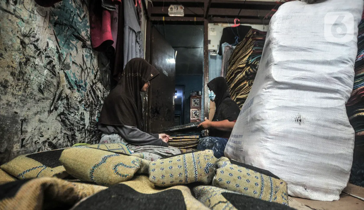 Fitri (40) menyelesaikan jasa sablon sajadah di Amang Sablon, Kebon Melati, Jakarta Pusat, Kamis (7/4/2022). Industri rumahan tersebut mengalami peningkatan sebesar 50 persen di bulan Ramadhan 1443 H jika dibandingkan bulan biasanya. (merdeka.com/Iqbal S. Nugroho)