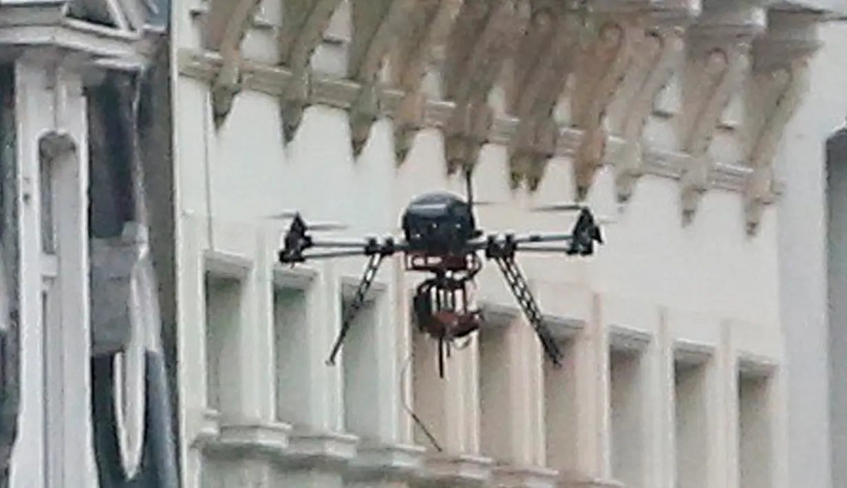 Drone milik kepolisian Belgia terbang mengawasi sebuah tempat terduga pelaku bom paris di Molenbeek, Brussel, Belgia, (8/3). Wilayah ini memang dihuni oleh imigran-imigran asal Afrika Utara. (REUTERS/VTM)