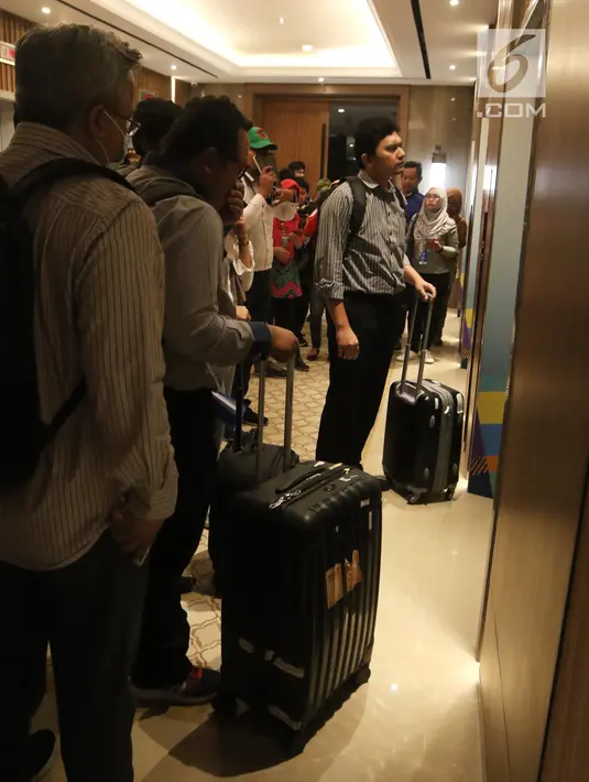 Sejumlah penyidik KPK bersiap memasuki lift saat menggeledah Kantor Pusat PLN, Jakarta, Senin (16/7). Setidaknya tiga petugas KPK terlihat membawa tiga buah koper. (Liputan6.com/Arya Manggala)
