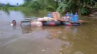Banjir menenggelamkan ribuan rumah dan berhektar sawah siap panen di Konawe, Juni 2018. (foto: Liputan6.com/ahmad akbar fua)