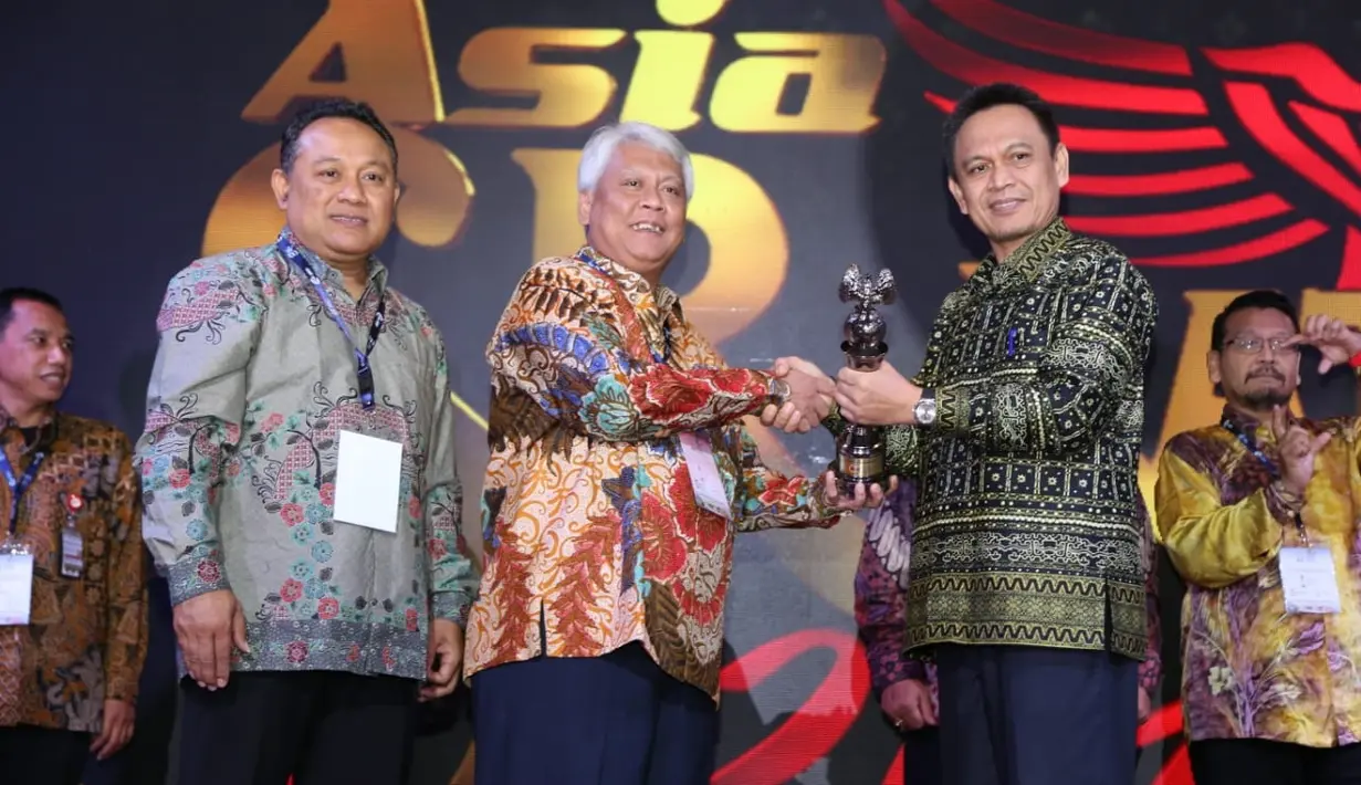 Direktur Transformasi Bisnis PT Pupuk Indonesia Nugroho Christijanto (tengah) menunjukan penghargaan SRA 2018 yang diraih Pupuk Indonesia Grup dalam acara The 14th Sustainability Reporting Award (SRA) di Lampung, Sabtu (8/12). (Liputan6.com/HO/Ines)