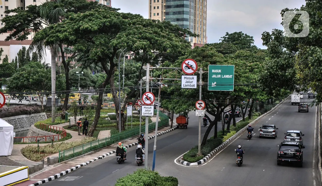 Kendaraan melintas di depan Taman Biotrans, Cempaka Putih, Jakarta, Minggu (19/12/2021). Taman seluas 2.500 meter persegi tersebut diharapkan dapat berfungsi sebagai pengendalian banjir, terbuka hijau serta tempat warga merasakan ruang terbuka yang dekat dengan alam. (merdeka.com/Iqbal S. Nugroho)