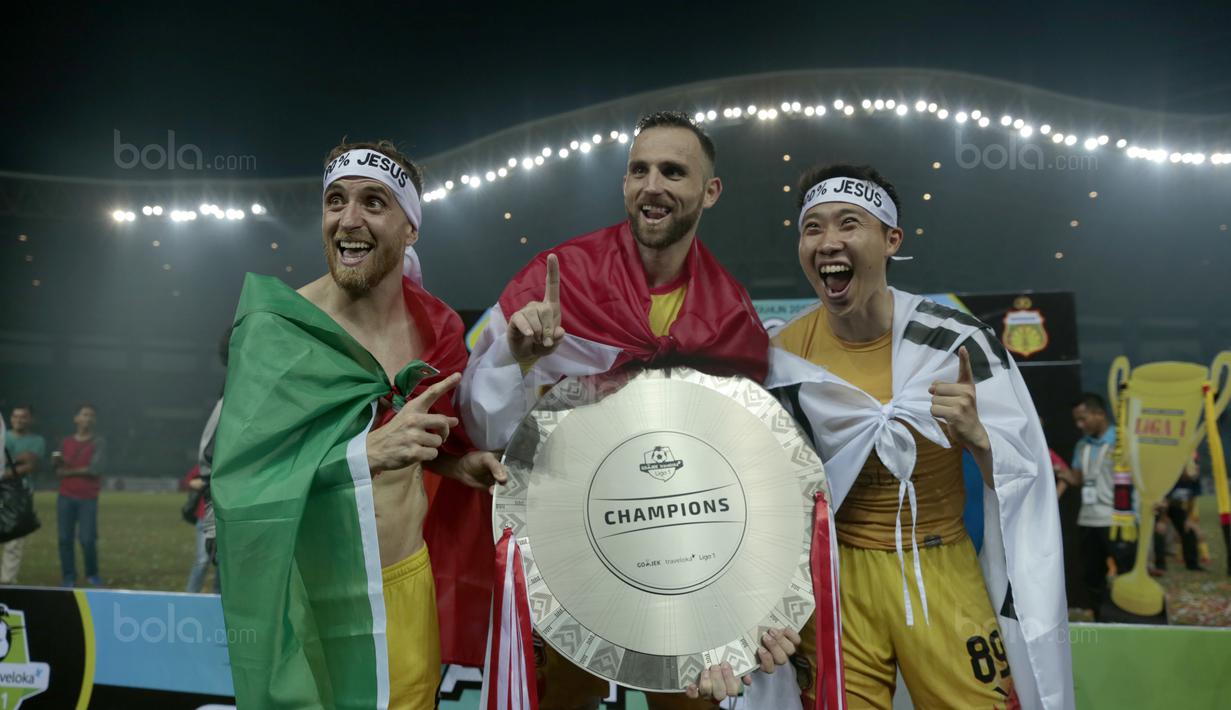 Pemain Bhayangkara FC, Paulo Sergio, Ilija Spasojevic, Lee Yoo-Joon merayakan keberhasilan meraih gelar juara Liga 1 2017 di Stadion Patriot Bekasi, Sabtu (12/11/2017). Bhayangkara kalah 1-2 lawan Persija. (Bola.com/Nicklas Hanoatubun)