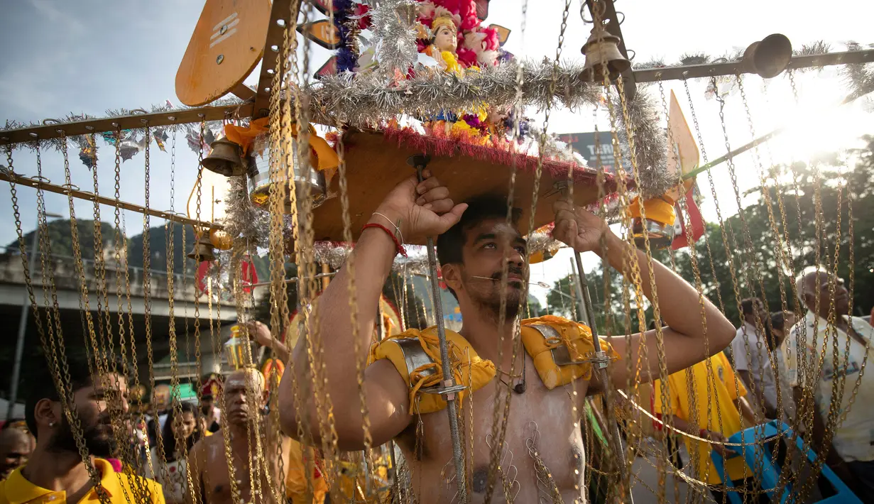 Seorang pria membawa sangkar kurban Kavadi saat Festival Thaipusam di Gua Batu, Kuala Lumpur, Malaysia, Senin (21/1). Thaipusam merupakan hari menunaikan nazar, menebus dosa, dan memohon ampun atas dosa-dosa. (AP Photo/ Vincent Thian)