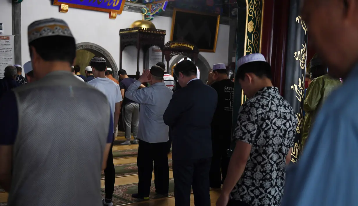 Sejumlah pria muslim saat melaksanakan salat Jumat pertama pada bulan Ramadan 1440 H di sebuah masjid di Beijing (10/5/2019). (AFP Photo/Greg Baker)