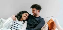 Happy Couple/copyright Pexels.com https://www.pexels.com/photo/smiling-multiracial-couple-hugging-on-couch-6392957/