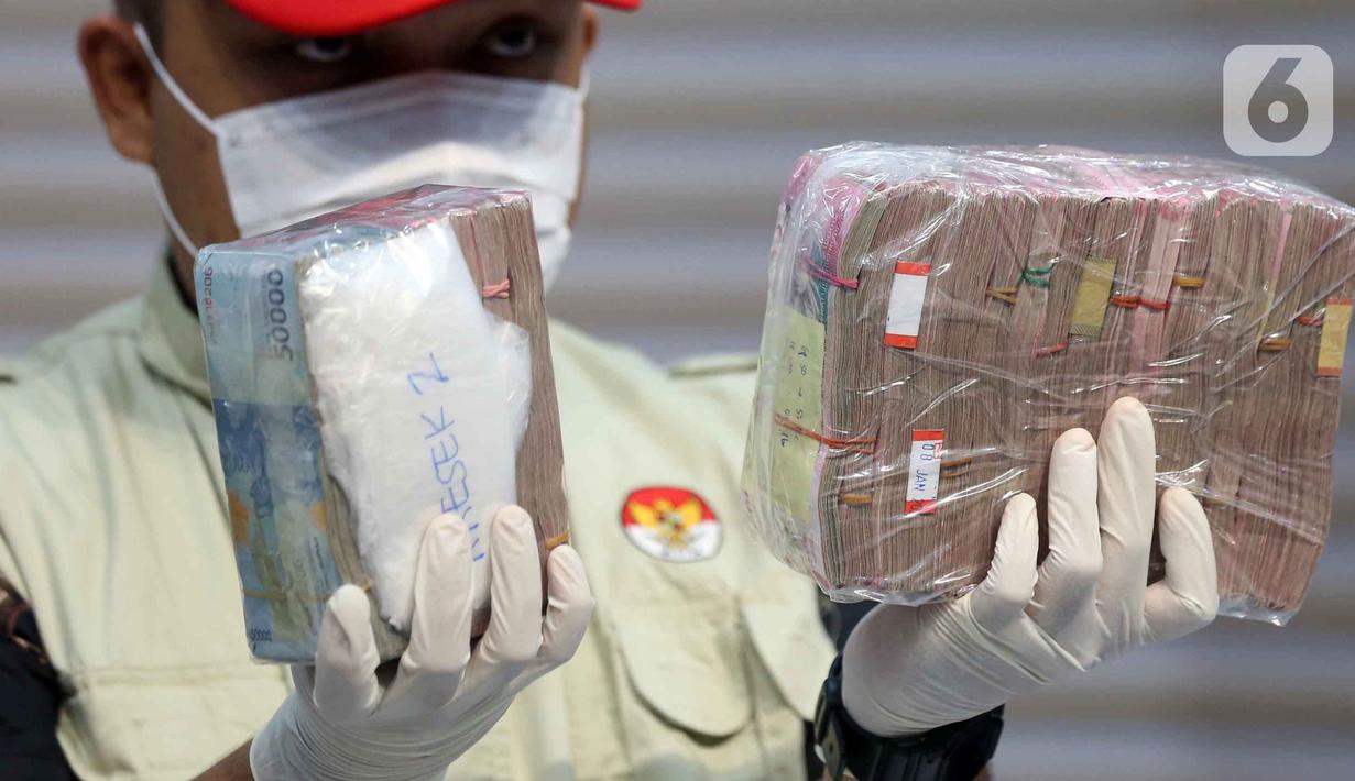 Petugas menunjukkan tumpukan uang barang bukti Operasi Tangkap Tangan (OTT) Bupati Pati Sudewo di Gedung Merah Putih Komisi Pemberantasan Korupsi (KPK), Jakarta, Selasa (20/1/2026). (Liputan6.com/Helmi Fithriansyah)