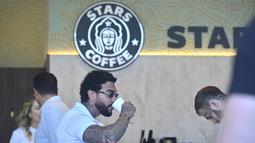 Penyanyi dan pengusaha Rusia Timur Yunusov, lebih dikenal sebagai Timati, minum kopi di kedai kopi Stars Coffee yang baru dibuka di bekas lokasi kedai kopi Starbucks di Moskow, Kamis (18/8/2022). Jaringan kedai kopi baru dibuka pada Kamis di Moskow, setelah Timur Yunusov bersama dengan pemilik restoran Rusia Anton Pinskiy membeli toko Starbucks setelah hengkangnya perusahaan asing dari negara itu. (AP Photo/Dmitry Serebryakov)