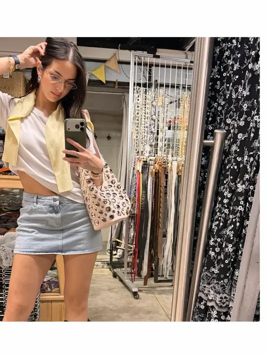 Dengan busana kasual, ibu tiga anak itu padukan t-shirt dan rok mini dengan cardigan pastel. Aksesori kacamata dengan frame tipis bikin Nia Ramadhani terlihat makin awet muda [@ramadhaniabakrie]