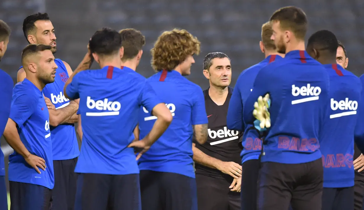 Pemain Barcelona mendengarkan pelatih Ernesto Valverde  selama sesi latihan di Stadion Atletik Kota Machida di Tokyo (22/7/2019). Barcelona akan bertanding melawan Chelsea pada laga pramusim di ajang trofeo Rakuten Cup 2019 di Stadion Saitama. (AFP Photo/Kazuhiro Nogi)