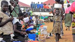 Warga menjual makanan di Pos Perbatasan Ngomoromo, Uganda, Senin (10/4). Menurut UNHCR lebih dari 6.000 orang Sudan Selatan telah melarikan diri ke distrik Uganda utara Lamwo sejak perang meletus pada 3 April. (AFP PHOTO / ISAAC KASAMANI)