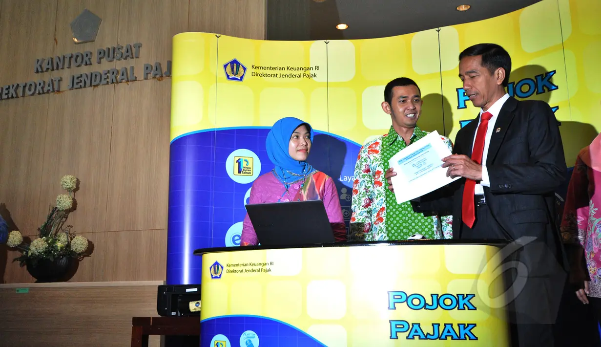 Presiden Joko Widodo (kanan) dibantu petugas mengisi surat pemberitahuan tahunan (SPT) pajak penghasilan menggunakan sistem e-filling di Kantor Pusat Ditjen Pajak Jakarta, Kamis (19/3/2015). (Liputan6.com/Faizal Fanani)