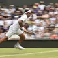 Roger Federer mengejar bola pada laga babak pertama Wimbledon 2019 melawan Lloyd Harris. (AFP/Glyn Kirk)