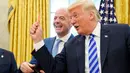Presiden FIFA Gianni Infantino (tengah) tertawa saat Presiden AS Donald Trump memegang kartu merah selama pertemuan di Oval Office Gedung Putih pada Selasa (28/8). Presiden FIFA bertemu Trump untuk membahas kesiapan Piala Dunia 2026. (AFP/Mandel Ngan)