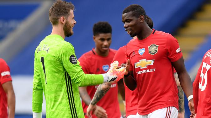 Kiper Manchester United, David de Gea berselebrasi dengan gelandang timnya, Paul Pogba pada akhir partai pamungkas Liga Inggris menghadapi Leicester City di Stadion King Power, Minggu (26/7/2020). MU lolos ke Liga Champions musim depan usai mengalahkan Leicester City 2-0. (Michael Regan/Pool via AP)