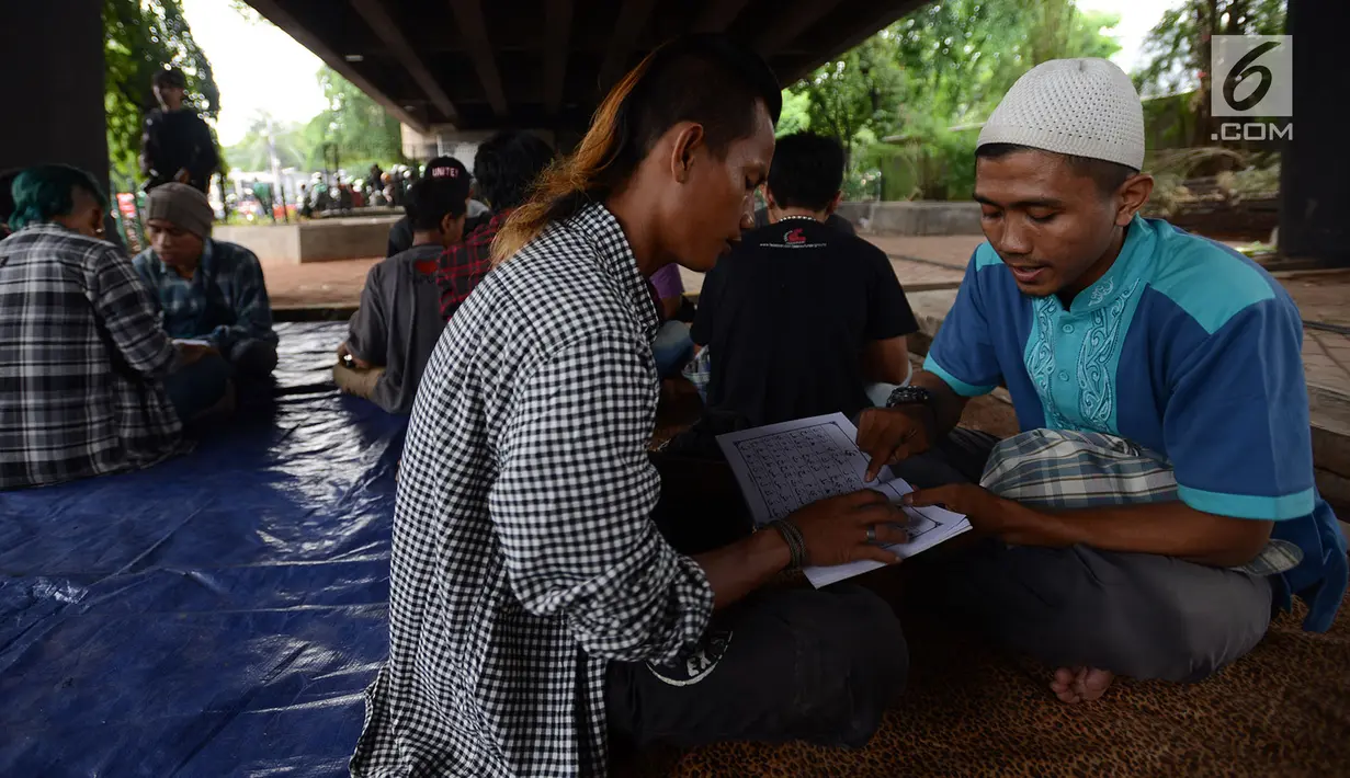 Anak punk saat belajar mengaji dengan Iqro bersama Komunitas Tasawuf Underground di kolong flyover Tebet, Jakarta, Sabtu (8/12). Komunitas ini mengajak anak-anak punk dan anak jalanan kembali ke kehidupan yang baik. (Merdeka.com/Imam Buhori)
