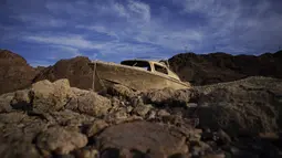 Sebuah perahu yang sebelumnya tenggelam berada di ketinggian dan kering di sepanjang garis pantai Danau Mead di area rekreasi Danau Mead dekat Boulder City, negara bagian Nevada, pada Selasa, 10 Mei 2022. Danau Mead, salah satu waduk terbesar di AS, yang selama ini digunakan sebagai waduk dan tempat penampungan air kondisinya mengering. (AP Photo/John Locher)