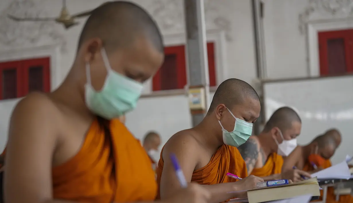 Sejumlah Biksu Buddha memakai masker untuk membantu melindungi diri dari virus corona, mengikuti tes bahasa Pali liturgi di Wat Molilokayaram di Bangkok, Thailand, Kamis (20/1/2022). (AP Photo/Sakchai Lalit)