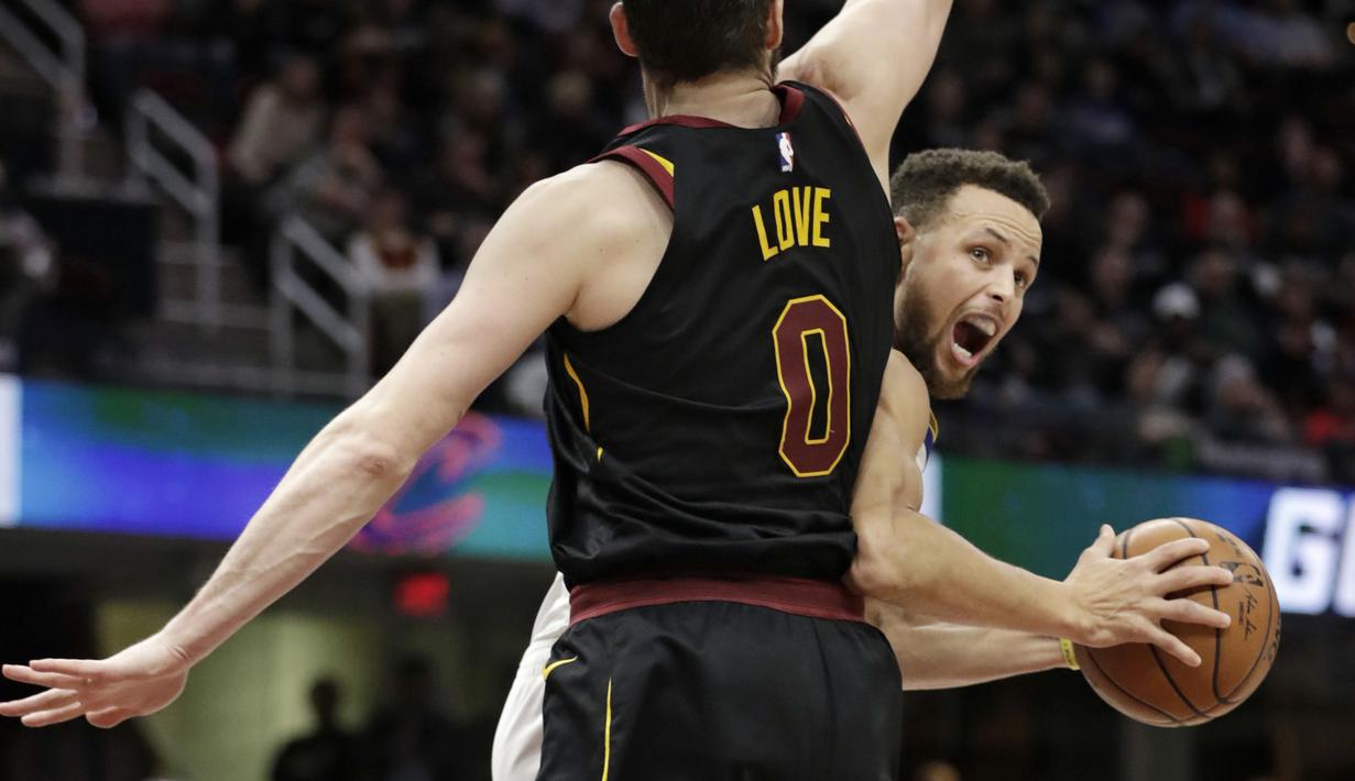 Aksi pemain Warriors, Stephen Curry (kanan) melewati adangan pemain Cavaliers, Kevin Love pada lanjutan NBA basketball game di Quicken Loans Arena, Cleveland, (15/1/2018). Warriors menang 118-108. (AP/Tony Dejak)