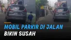Beberapa mobil di parkir di jalan membuat susah pengguna jalan lain. Kejadian itu terjadi di Jalan Gajayana, Gang 1 Dinoyo, Malang, Jawa Timur.