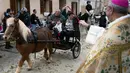 Seekor kuda poni diberkati selama upacara tradisional 'Beneides' pada peringatan Hari santo Antonius di Muro, pulau Balearic Spanyol, Kamis (17/1). Pada perayaan tahunan itu, para pemilik membawa hewan peliharaan untuk diberkati pastor. (JAIME REINA/AFP)