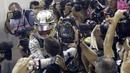 Pebalap Mercedes, Lewis Hamilton merayakan kemenangan bersama tim mekanik pada balapan F1 GP Singapura di  Marina Bay City Circuit, (17/9/2017). Hamilton kini memiliki total poin 263. (AP/Wong Maye-E)